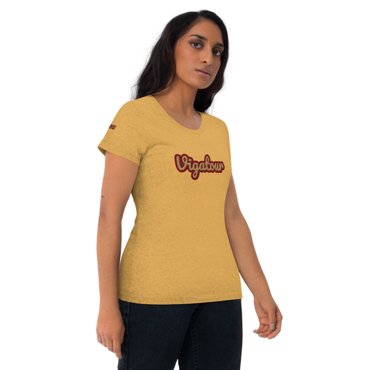 Woman wearing a mustard yellow t-shirt with 'Vigatour' printed on it against a white background
