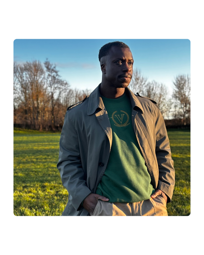 Man wearing the Core V Sweatshirt in Forest Green under a trench coat, outdoors. Vigatour Mark I