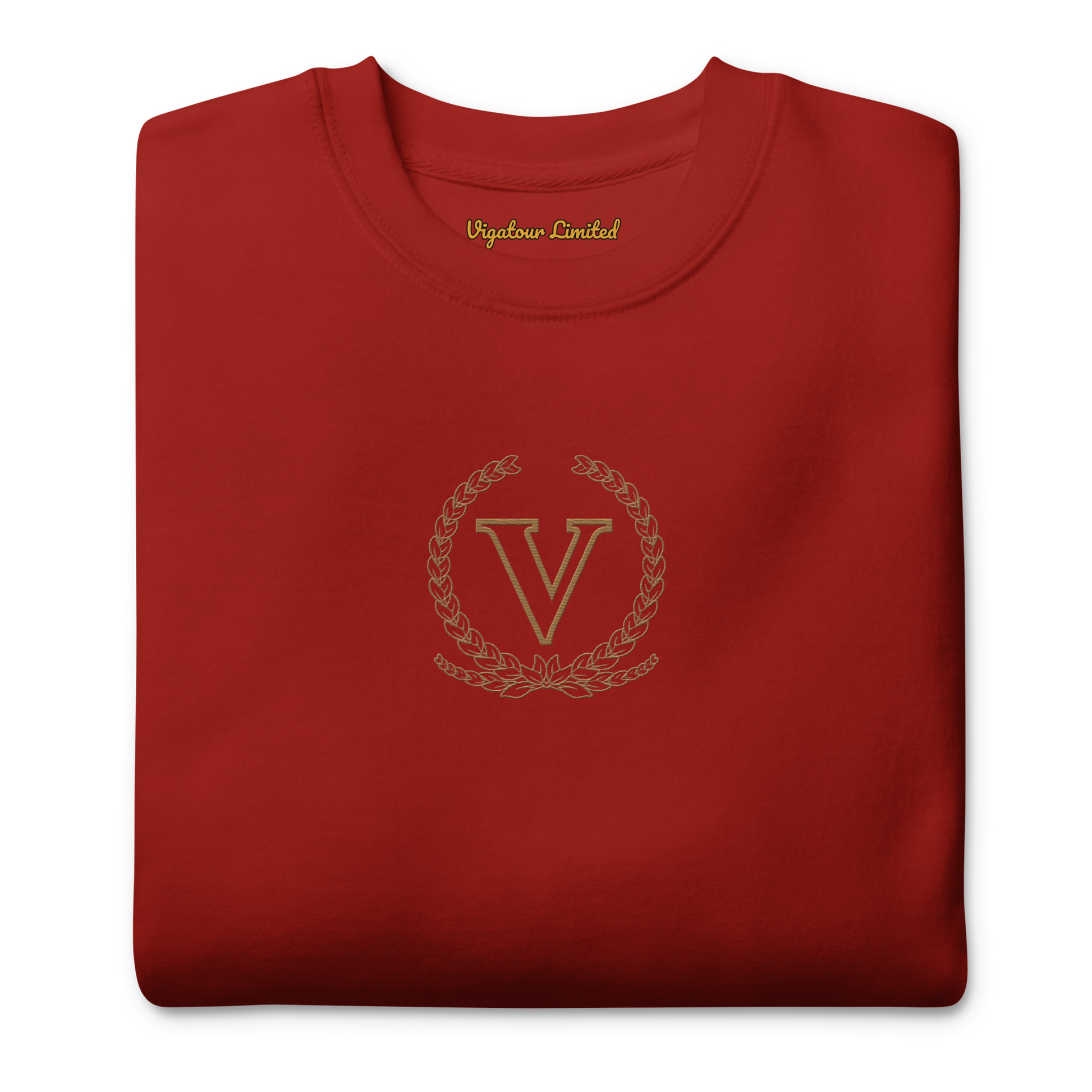 Folded red sweatshirt with a gold logo and text on a white background