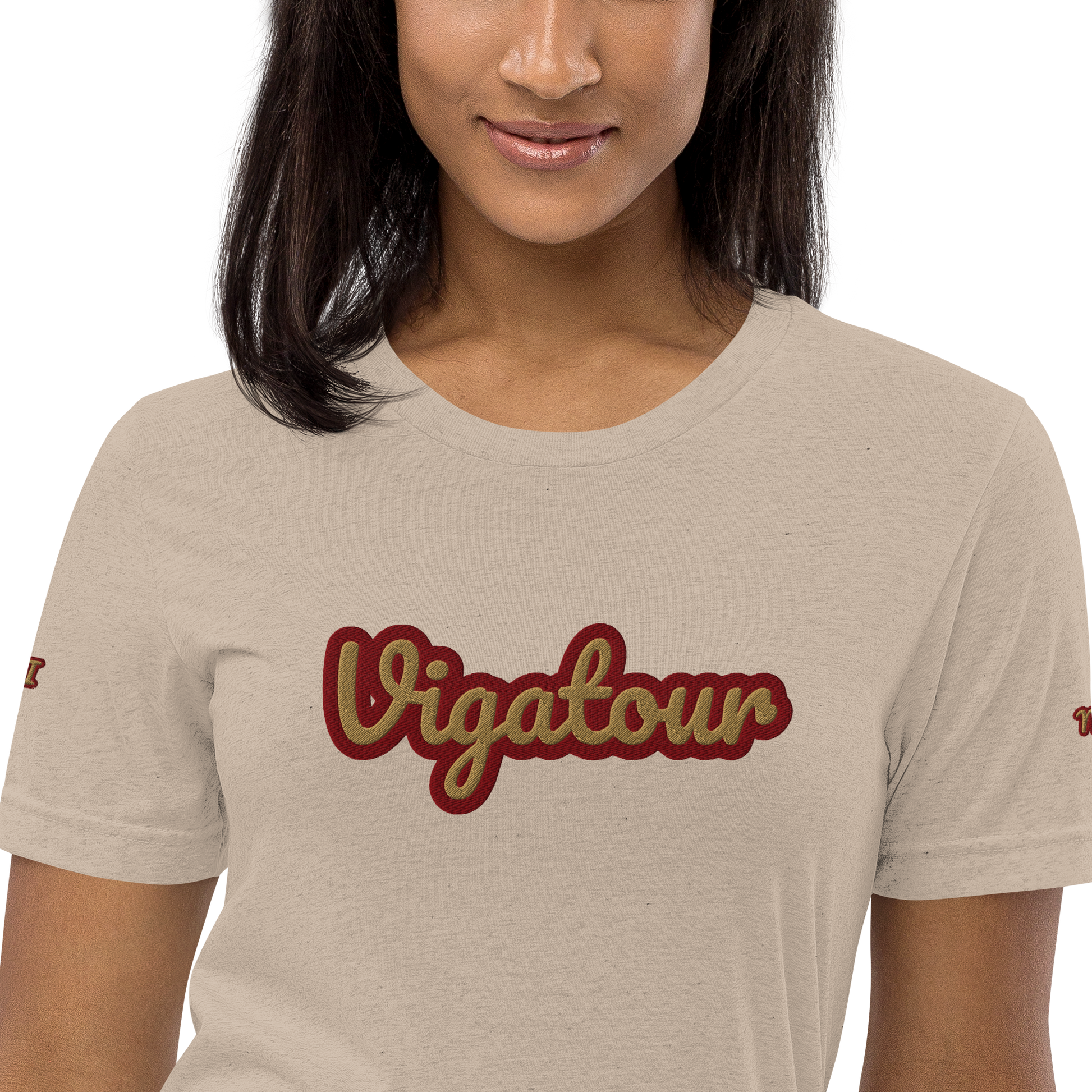 Person wearing a beige t-shirt with 'Vigatour' printed in red.